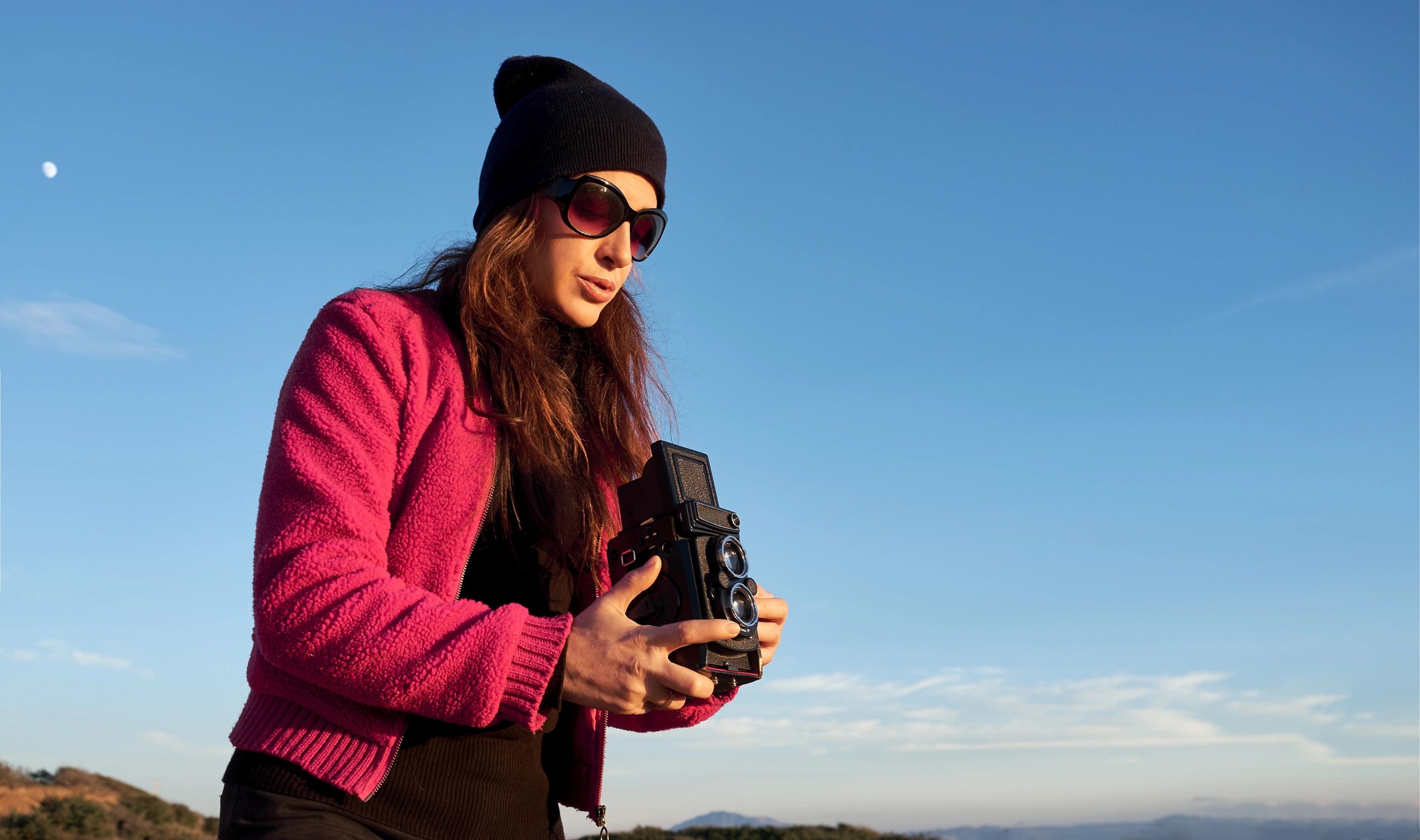 Photographer taking pictures outdoors with camera