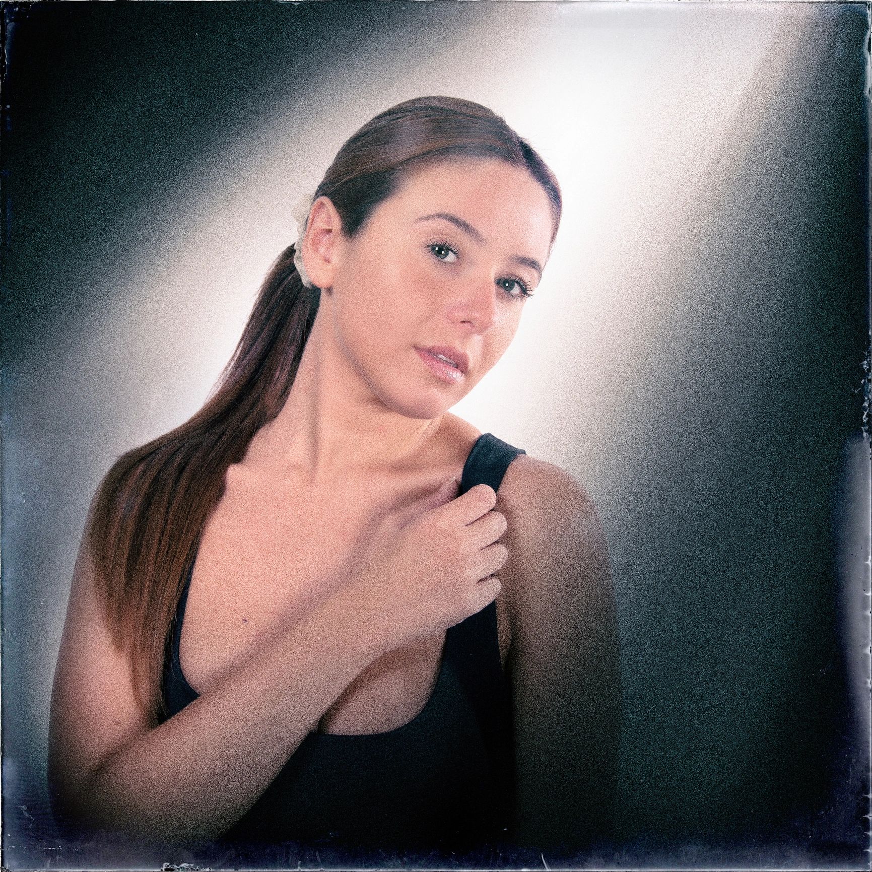 Portrait of a young woman in soft spotlight